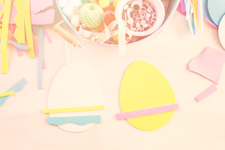 Step by step. Mother and daughter decorating paper Easter eggs.