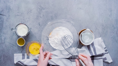 Step by step. Flat lay. Mixing ingredients together in glass mixing bowl for spicy jalapeno...