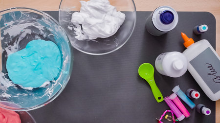 Step by step. Flat lay. Kids project with colorful fluffy slime.