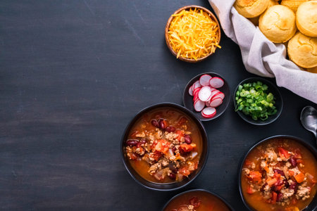 Turkey chili garnished with fresh radishes, green onions and cheddar cheese.