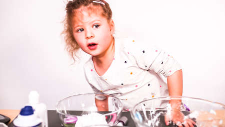 Step by step. Little girl baking sugar skull cookies for Dia de los Muertos holiday.の写真素材