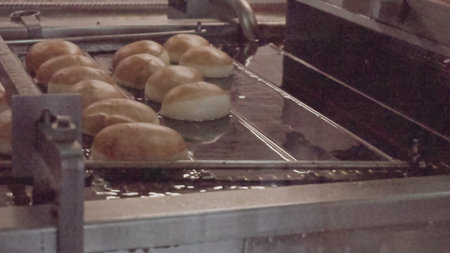 Industrial production of donuts by machine.