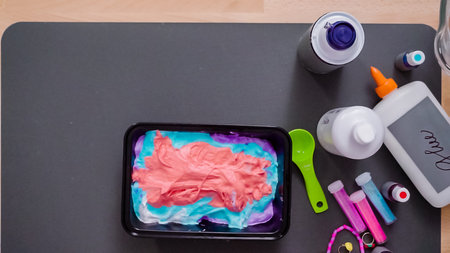 Step by step. Flat lay. Kids project with colorful fluffy slime.の写真素材