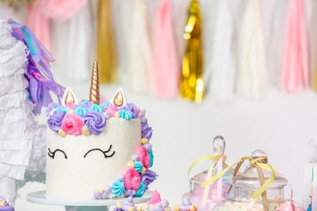 Little girl birthday party table with unicorn cake, cupcakes, and sugaer cookies.の写真素材