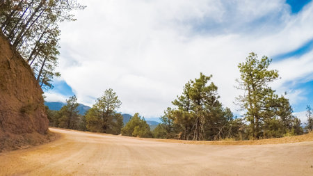 Driving on small mountain dirt roads from Colorado Springs to Cripple Creek in Autumn.