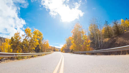 Driving on mountain highway 67 to Victor in Autumn.の写真素材