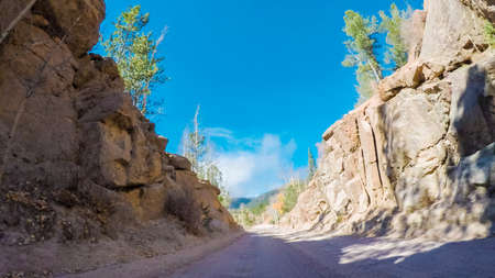 Driving on small mountain dirt roads from Colorado Springs to Cripple Creek in Autumn.の写真素材