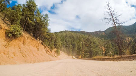 Driving on small mountain dirt roads from Colorado Springs to Cripple Creek in Autumn.の写真素材