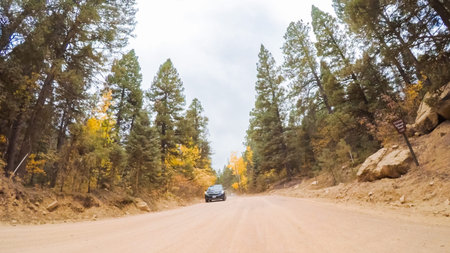 Driving on small mountain dirt roads from Colorado Springs to Cripple Creek in Autumn.