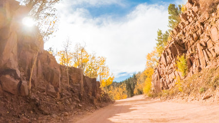 Driving on small mountain dirt roads from Colorado Springs to Cripple Creek in Autumn.