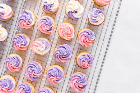 Baking small cupcakes with unicorn theme.