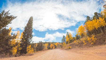 Driving on small mountain dirt roads from Colorado Springs to Cripple Creek in Autumn.