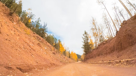 Driving on small mountain dirt roads from Colorado Springs to Cripple Creek in Autumn.