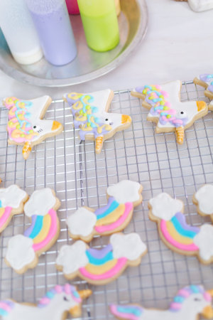 Decorating unicorn themed sugar cookies with royal icing.の写真素材