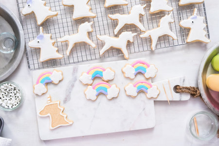 Decorating unicorn themed sugar cookies with royal icing.