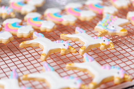 Decorating unicorn themed sugar cookies with royal icing.の写真素材