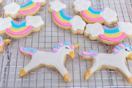 Decorating unicorn themed sugar cookies with royal icing.の写真素材