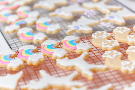 Decorating unicorn themed sugar cookies with royal icing.の写真素材