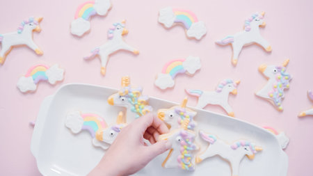 Unicorn sugar cookies decorated with royal icing on pink background.の写真素材