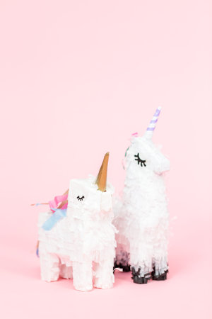 White unicorn pinata on a pink background.の写真素材