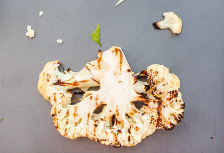 Grilled cauliflower on a metal tray.の写真素材