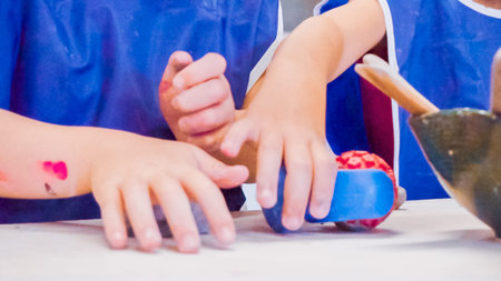Little girls creating small kids sculptures from clay.の写真素材