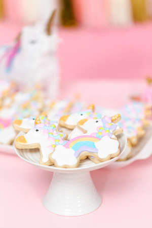 Unicorn sugar cookies decorated with royal icing in white cake stand.の写真素材
