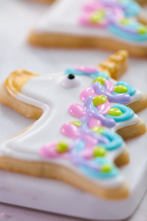 Decorating unicorn themed sugar cookies with royal icing.