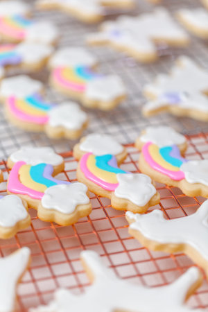 Decorating unicorn themed sugar cookies with royal icing.
