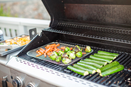Cooking healthy dinner on outdoor gas grill.の写真素材