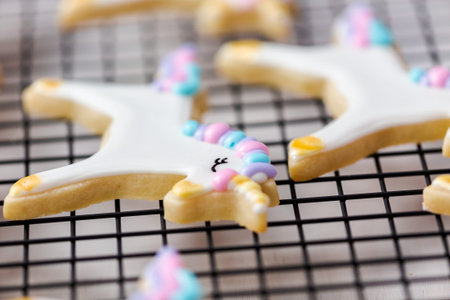 Decorating unicorn themed sugar cookies with royal icing.の写真素材