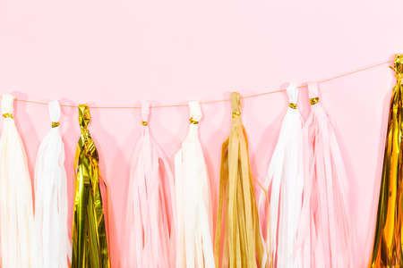 Paper tassel garland on a pink wall at the kids birthday party.の写真素材