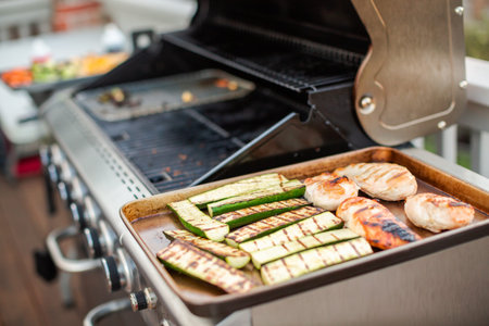 Cooking healthy dinner on outdoor gas grill.