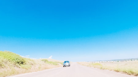 Driving on dirt road through open space in rural suburbia in Colorado.の写真素材