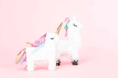 White unicorn pinata on a pink background.の写真素材