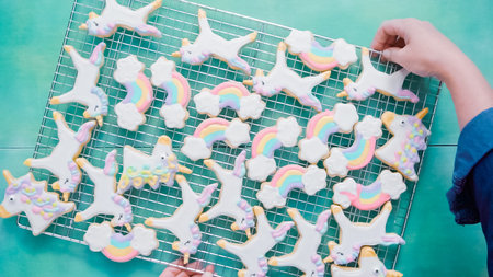 Unicorn sugar cookies decorated with royal icing on blue background.の写真素材