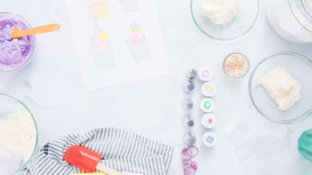 Step by step. Coloring buttercream frosting with food colors for unicorn theme vanilla cupcakes.の写真素材