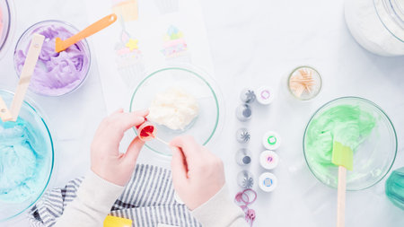 Step by step. Coloring buttercream frosting with food colors for unicorn theme vanilla cupcakes.