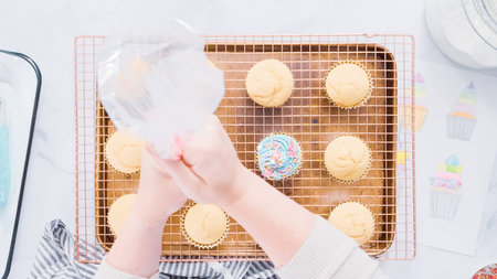 Step by step. Decorating unicorn themed vanilla cupcakes with rainbow buttercream frosting.