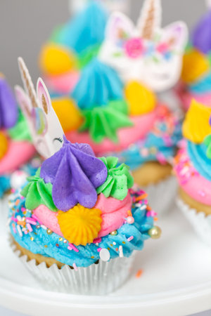 Close up of unicorn cupcakes with multicolor buttercream icing.