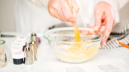 Step by step. Coloring buttercream frosting with food colors for unicorn theme vanilla cupcakes.の写真素材