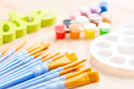 Green create sign with paint brushes on the table.の写真素材