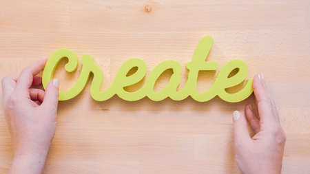 Green create sign with paint brushes on the table.の写真素材