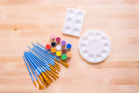 New paint supplies on a wood table.の写真素材