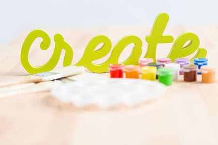 Green create sign with paint brushes on the table.の写真素材