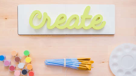 Green create sign with paint brushes on the table.の写真素材