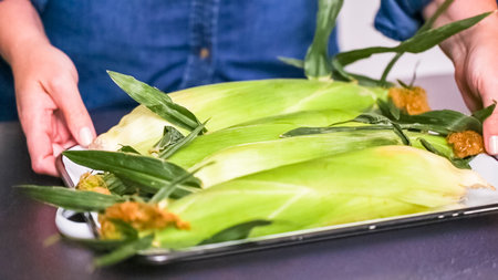 Step by step. Shucking fresh organic corn to make mexican corn salad.