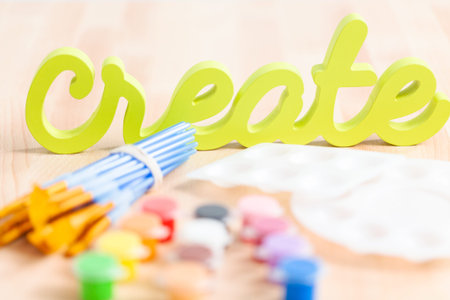 Green create sign with paint brushes on the table.の写真素材