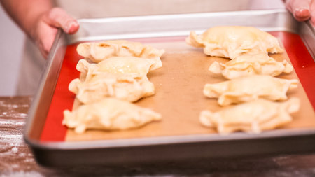 Step by step. Making home made empanadas with red apples fillings.の写真素材