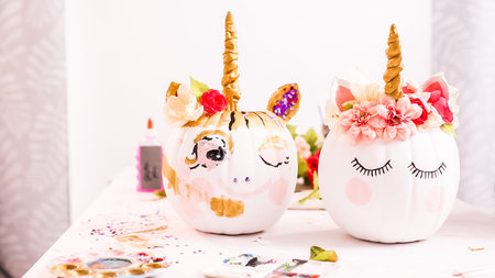 Decorating craft pumpkins with unicorn theme for Halloween.の写真素材